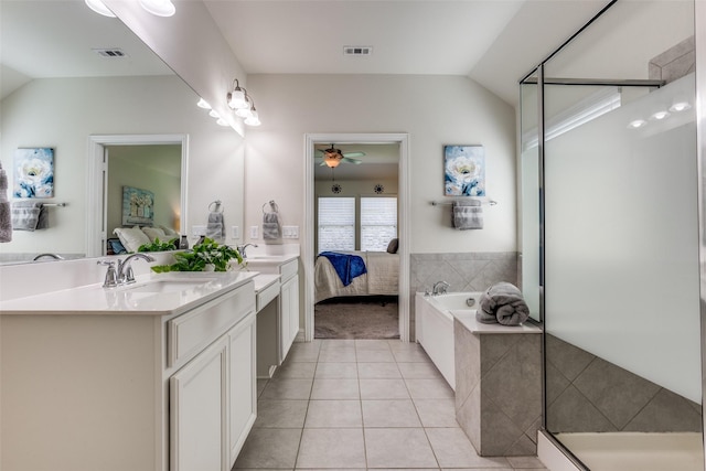 1814 Indigo Creek Ln, Wylie, TX 75098 - ensuite bathroom featuring tile patterned floors, double vanity, a garden tub, ceiling fan, and vaulted ceiling