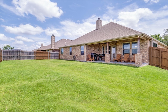 3118 Oak Crest Dr, Royse City, TX 75189 - back of property featuring a chimney, a patio area, brick siding, and a shingled roof