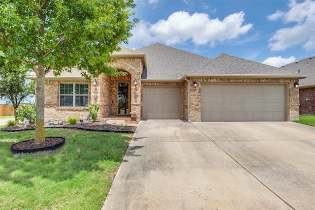 3118 Oak Crest Dr, Royse City, TX 75189 - view of front of property with an attached garage, concrete driveway, a shingled roof, and brick siding