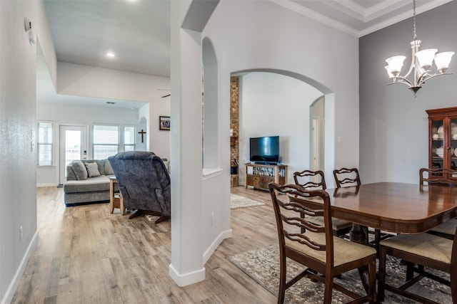 3118 Oak Crest Dr, Royse City, TX 75189 - dining area featuring arched walkways, light wood-style flooring, baseboards, a chandelier, and ornamental molding