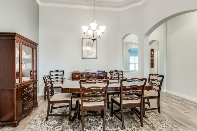3118 Oak Crest Dr, Royse City, TX 75189 - dining room featuring a chandelier, light wood-style floors, ornamental molding, baseboards, and arched walkways