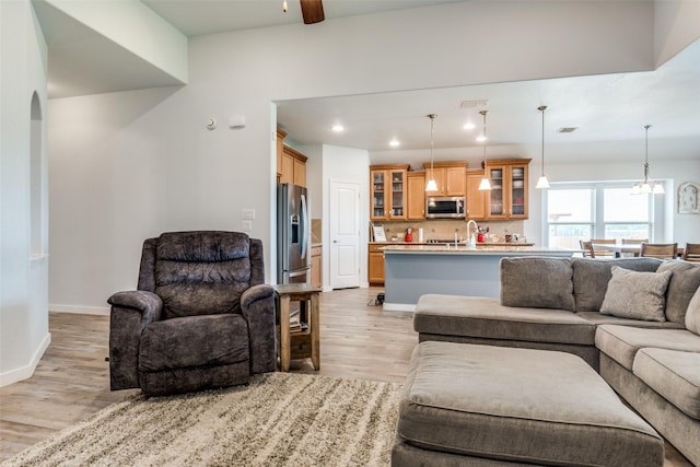 3118 Oak Crest Dr, Royse City, TX 75189 - living room featuring light wood-style floors, baseboards, ceiling fan, a chandelier, and recessed lighting