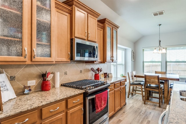 3118 Oak Crest Dr, Royse City, TX 75189 - kitchen with stainless steel appliances, light wood-type flooring, vaulted ceiling, tasteful backsplash, and a chandelier