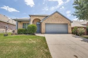 3820 Denridge Ln, Fort Worth, TX 76262 - view of front facade with an attached garage, driveway, and a front lawn