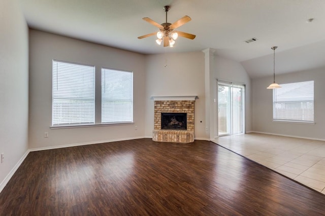 3820 Denridge Ln, Fort Worth, TX 76262 - unfurnished living room with a ceiling fan, wood finished floors, a brick fireplace, baseboards, and lofted ceiling