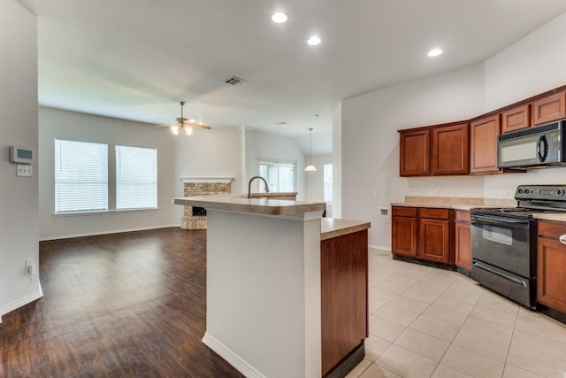 3820 Denridge Ln, Fort Worth, TX 76262 - kitchen with black appliances, a ceiling fan, healthy amount of natural light, open floor plan, and recessed lighting