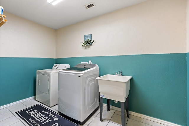 300 Burtonwood Cir, Ovilla, TX 75154 - laundry room with washing machine and clothes dryer, light tile patterned floors, and baseboards