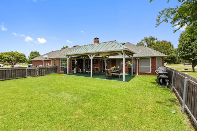 300 Burtonwood Cir, Ovilla, TX 75154 - back of house with a chimney, brick siding, and a patio