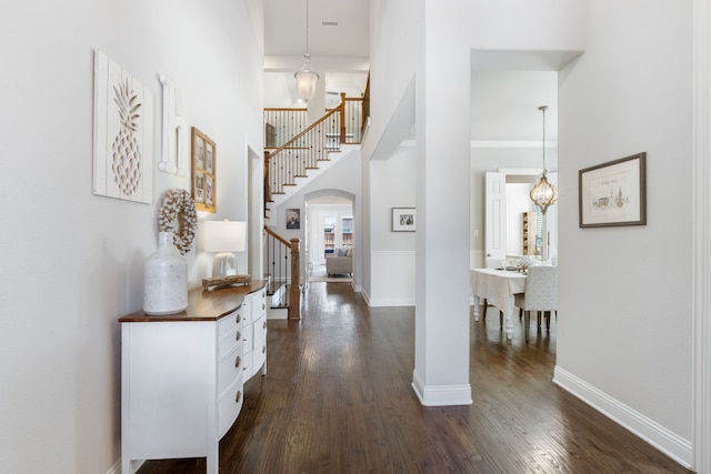 3025 Speyburn, The Colony, TX 75056 - entrance foyer with stairs, dark wood-style flooring, baseboards, arched walkways, and a towering ceiling