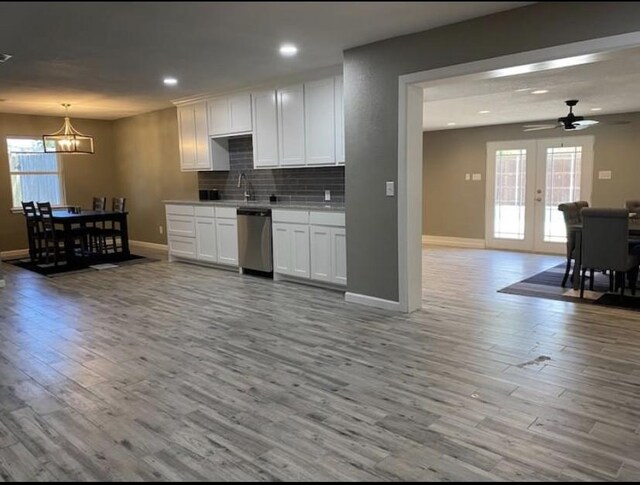 1432 Hurstview Dr, Hurst, TX 76053 - kitchen featuring dishwasher, a chandelier, light wood-type flooring, baseboards, and white cabinetry