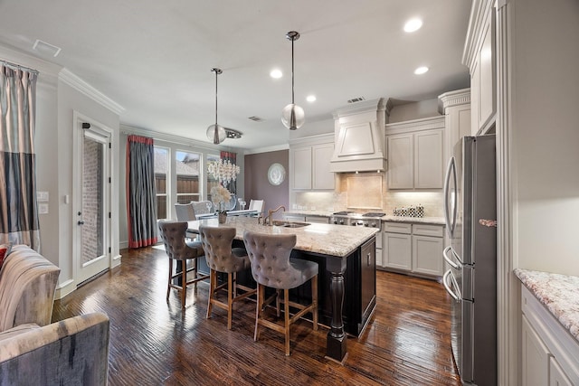 6208 Jacqueline Dr, Plano, TX 75024 - kitchen with freestanding refrigerator, custom exhaust hood, a sink, a kitchen breakfast bar, and decorative backsplash
