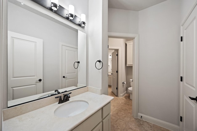 6208 Jacqueline Dr, Plano, TX 75024 - bathroom with toilet, vanity, tile patterned flooring, and baseboards