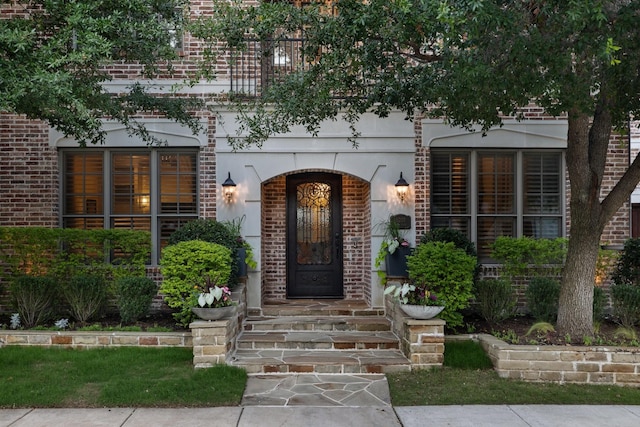 6208 Jacqueline Dr, Plano, TX 75024 - view of exterior entry featuring brick siding and stucco siding
