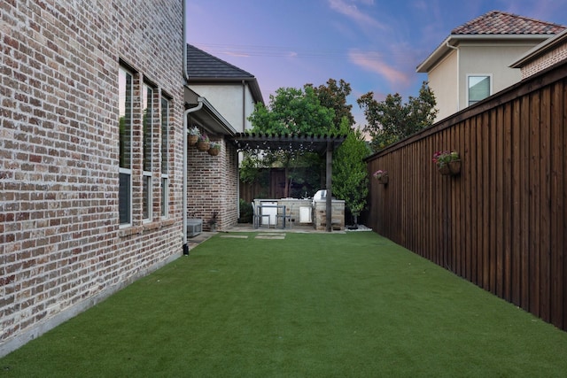 6208 Jacqueline Dr, Plano, TX 75024 - yard at dusk featuring a pergola, exterior kitchen, and a patio area