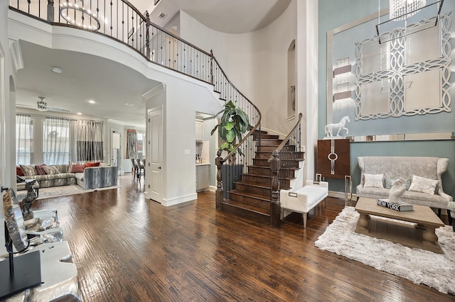 6208 Jacqueline Dr, Plano, TX 75024 - living room featuring a high ceiling, arched walkways, wood finished floors, a ceiling fan, and stairs
