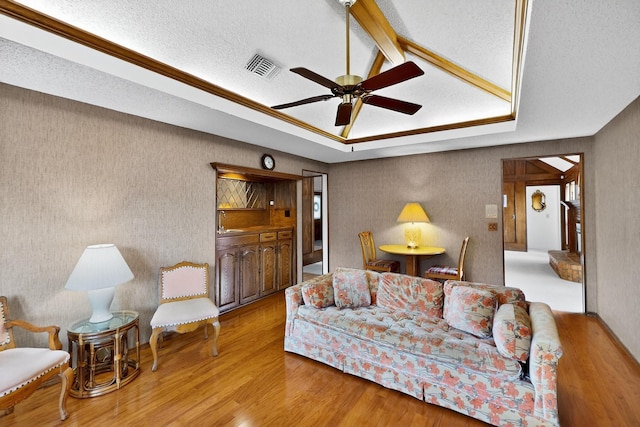 2521 La Vida Pl, Plano, TX 75023 - living area with ceiling fan, wood finished floors, wallpapered walls, a textured ceiling, and lofted ceiling