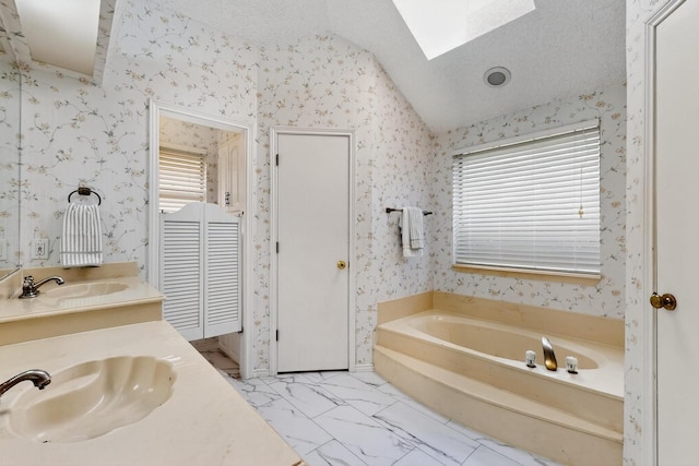 2521 La Vida Pl, Plano, TX 75023 - full bathroom featuring lofted ceiling, vanity, a bath, wallpapered walls, and a skylight
