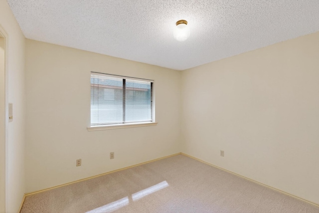 2521 La Vida Pl, Plano, TX 75023 - empty room with a textured ceiling, carpet floors, and baseboards
