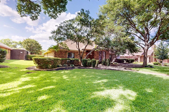 2521 La Vida Pl, Plano, TX 75023 - view of property hidden behind natural elements featuring a front yard and brick siding