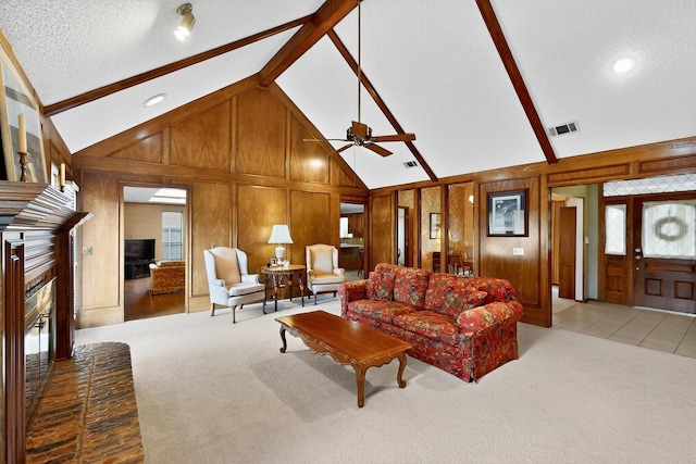 2521 La Vida Pl, Plano, TX 75023 - living area with a fireplace, carpet, wood walls, a ceiling fan, and high vaulted ceiling