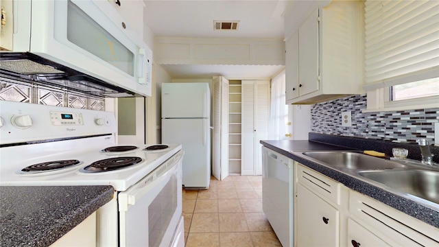 10502 Aledo Dr, Dallas, TX 75228 - kitchen featuring white appliances, dark countertops, and white cabinetry