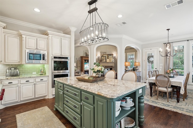 12669 Winding Hollow Ln, Frisco, TX 75033 - kitchen with a chandelier, appliances with stainless steel finishes, green cabinets, arched walkways, and open shelves
