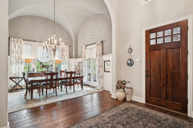 12669 Winding Hollow Ln, Frisco, TX 75033 - entrance foyer featuring wood-type flooring, a chandelier, arched walkways, high vaulted ceiling, and baseboards