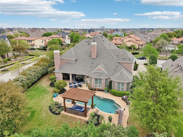 12669 Winding Hollow Ln, Frisco, TX 75033 - back of property featuring a chimney, a gazebo, a shingled roof, and a residential view