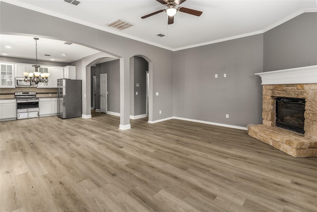 7500 Archer Way, Mckinney, TX 75072 - unfurnished living room featuring ceiling fan, baseboards, crown molding, light wood-style flooring, and a fireplace