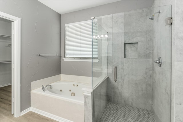 7500 Archer Way, Mckinney, TX 75072 - bathroom with a tub with jets, a stall shower, a spacious closet, and wood finished floors