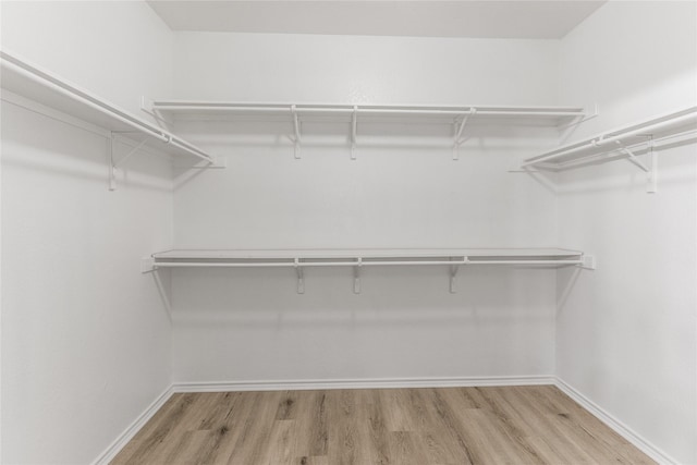 7500 Archer Way, Mckinney, TX 75072 - spacious closet featuring wood finished floors