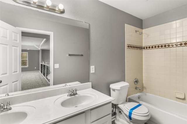 7500 Archer Way, Mckinney, TX 75072 - bathroom featuring double vanity, toilet, shower / washtub combination, and a textured wall