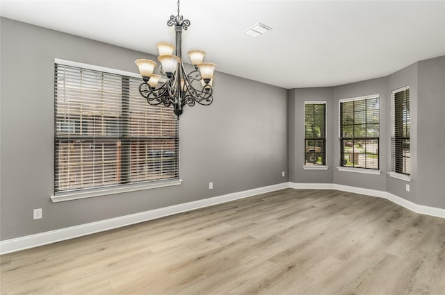 7500 Archer Way, Mckinney, TX 75072 - empty room with a chandelier, wood finished floors, and baseboards
