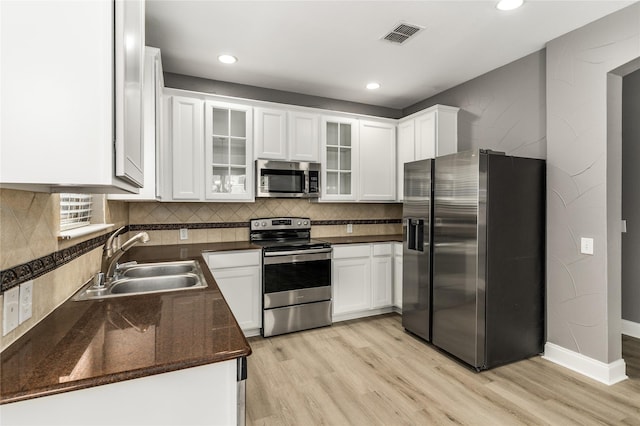 7500 Archer Way, Mckinney, TX 75072 - kitchen featuring appliances with stainless steel finishes, a sink, light wood-type flooring, white cabinets, and recessed lighting