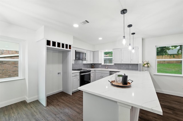 2428 Meadow Crk, Bedford, TX 76021 - kitchen with stainless steel appliances, a peninsula, dark wood-type flooring, decorative backsplash, and white cabinets