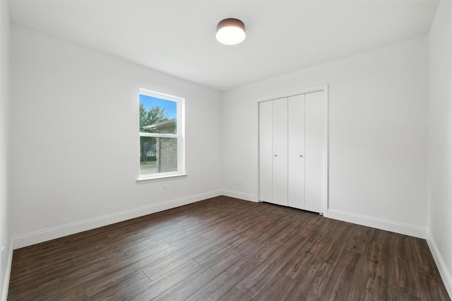 2428 Meadow Crk, Bedford, TX 76021 - unfurnished bedroom with dark wood-type flooring and a closet