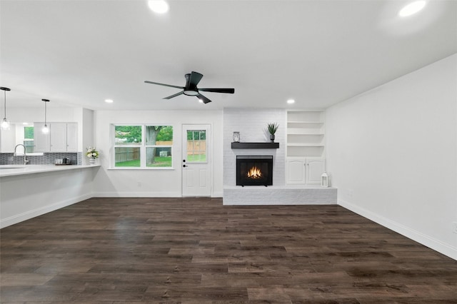 2428 Meadow Crk, Bedford, TX 76021 - unfurnished living room featuring recessed lighting, ceiling fan, a brick fireplace, and dark wood-style flooring