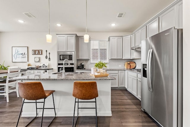 1021 Adelyn St, Anna, TX 75409 - kitchen with appliances with stainless steel finishes, a sink, a breakfast bar area, recessed lighting, and an island with sink