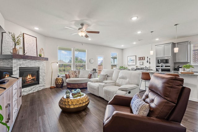 1021 Adelyn St, Anna, TX 75409 - living area featuring a fireplace, a ceiling fan, dark wood-style floors, and recessed lighting