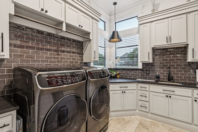1001 Colina Vista Ln, Crowley, TX 76036 - laundry room featuring washer and clothes dryer, crown molding, and cabinet space