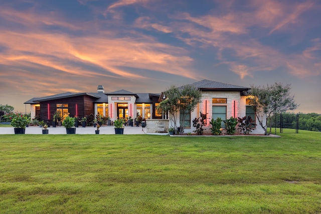 1001 Colina Vista Ln, Crowley, TX 76036 - back of house at dusk with a yard and stone siding