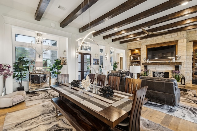 1001 Colina Vista Ln, Crowley, TX 76036 - dining room with wood-type flooring, a chandelier, a fireplace, healthy amount of natural light, and beam ceiling
