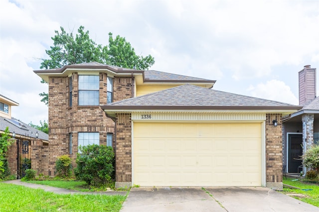 1336 Sheila Dr, Plano, TX 75023 - traditional-style home with concrete driveway, a garage, brick siding, and roof with shingles