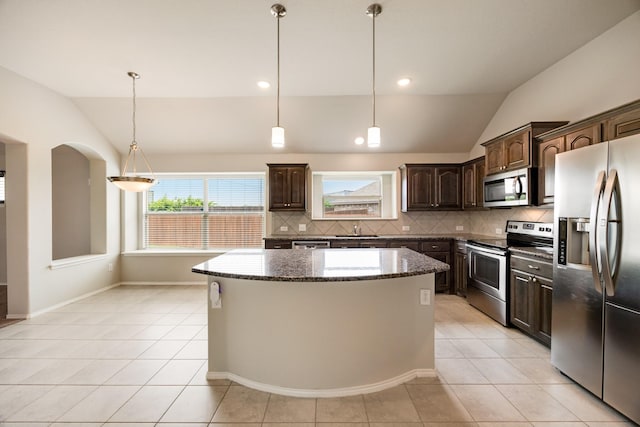 2133 Blakely Ct, Fort Worth, TX 76134 - kitchen featuring stainless steel appliances, vaulted ceiling, a sink, dark brown cabinetry, and a center island