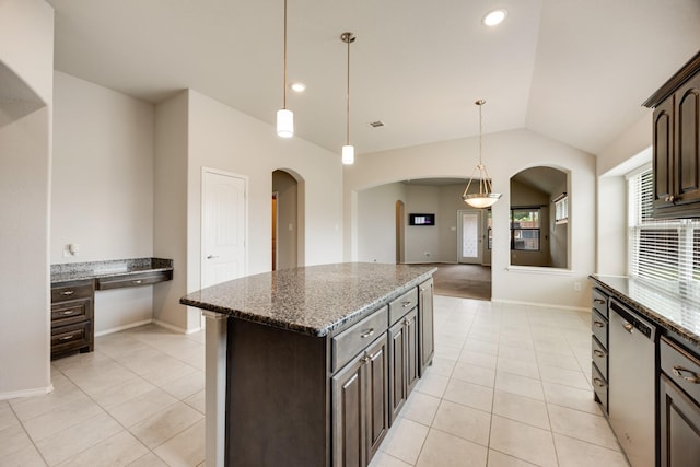 2133 Blakely Ct, Fort Worth, TX 76134 - kitchen featuring arched walkways, light tile patterned floors, dark brown cabinetry, vaulted ceiling, and recessed lighting