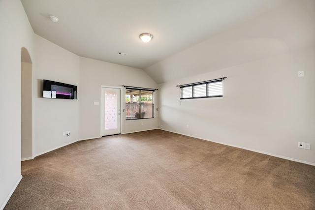 2133 Blakely Ct, Fort Worth, TX 76134 - carpeted spare room featuring vaulted ceiling, baseboards, a smoke detector, and arched walkways