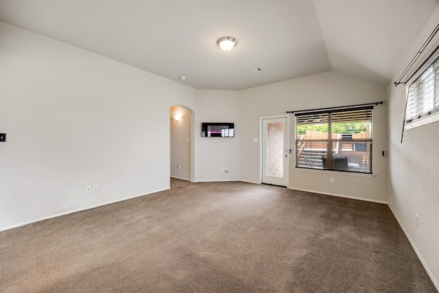 2133 Blakely Ct, Fort Worth, TX 76134 - spare room featuring arched walkways, carpet flooring, lofted ceiling, and baseboards