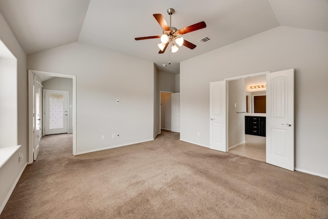 2133 Blakely Ct, Fort Worth, TX 76134 - unfurnished bedroom featuring vaulted ceiling, light colored carpet, connected bathroom, baseboards, and ceiling fan
