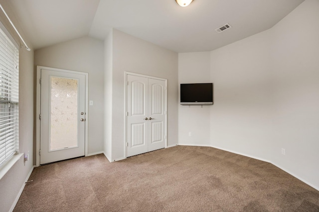 2133 Blakely Ct, Fort Worth, TX 76134 - unfurnished bedroom featuring carpet flooring, multiple windows, lofted ceiling, and a closet