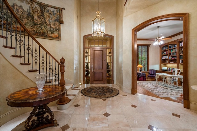 1524 Eastwick Ln, Plano, TX 75093 - foyer featuring baseboards, stairway, a chandelier, arched walkways, and a ceiling fan